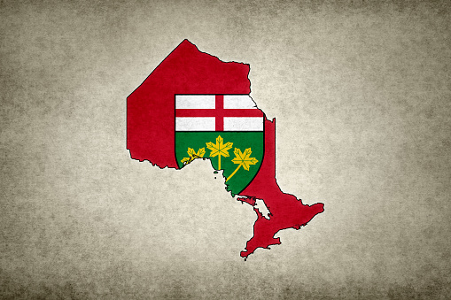 Grunge map of the province of Ontario (Canada) with its flag printed within its border on an old paper.
