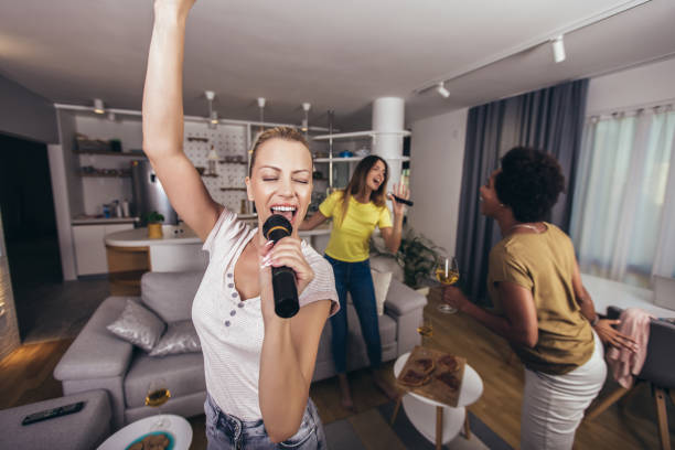 istock Women spend free time in karaoke, sing and have fun together 1299462348
