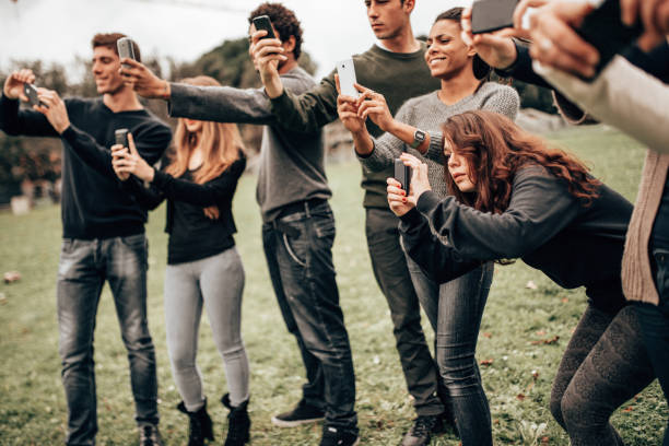 istock group of friends taking a pics outdoors 1299462483