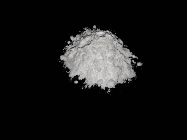 istock Cocaine drug powder on black background 1299463447