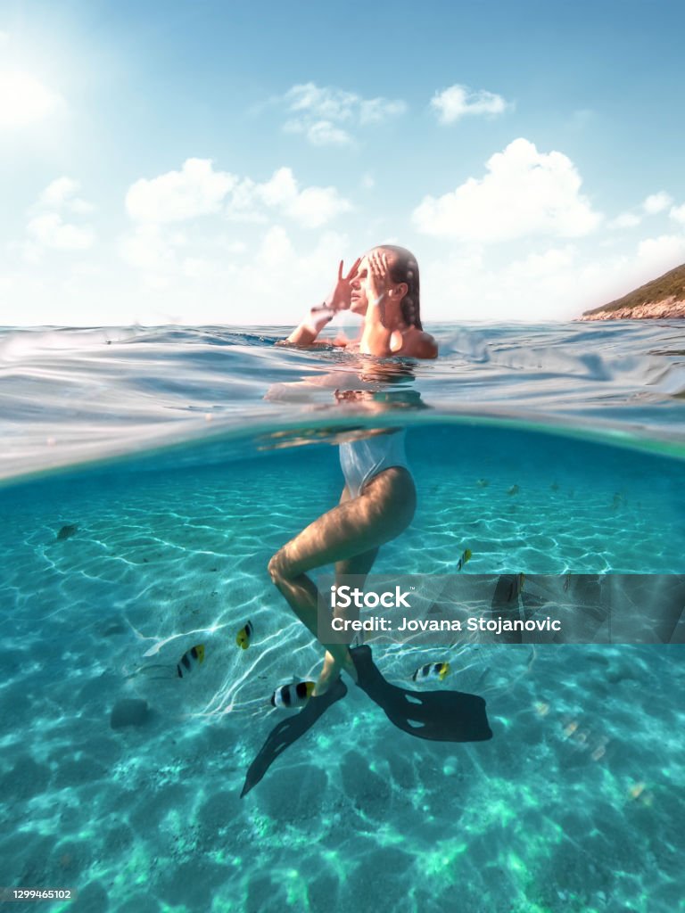 Swimming with fish in the sea Beach Stock Photo