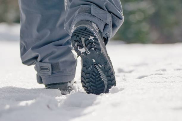 istock Man walking in the fresh white snow 1299466426
