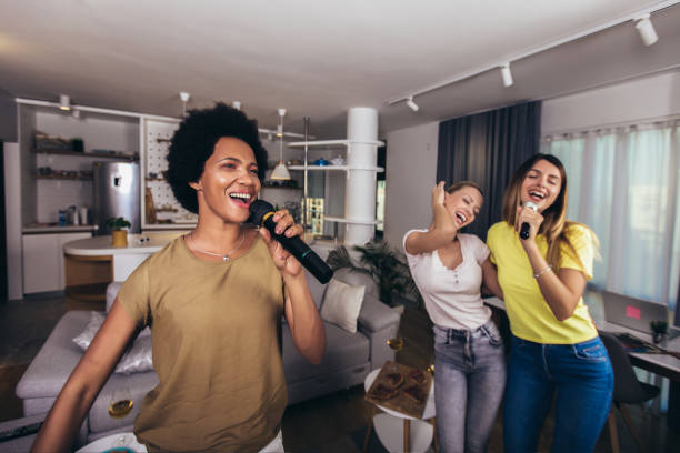 istock Women spend free time in karaoke, sing and have fun together 1299466963