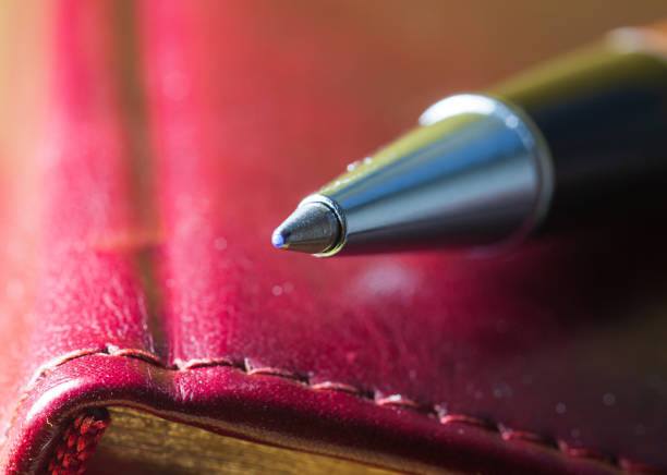 istock ballpoint pen lies on a notebook close-up 1299468207
