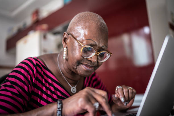 Senior woman using laptop at home