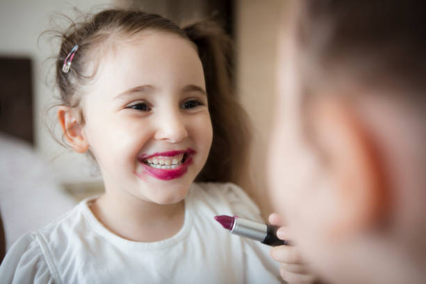 istock Little girl's first lipstick 1299471480