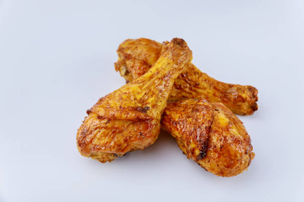 istock Grilled chicken drumsticks marinated with buffalo sauce isolated on white background. 1299472625