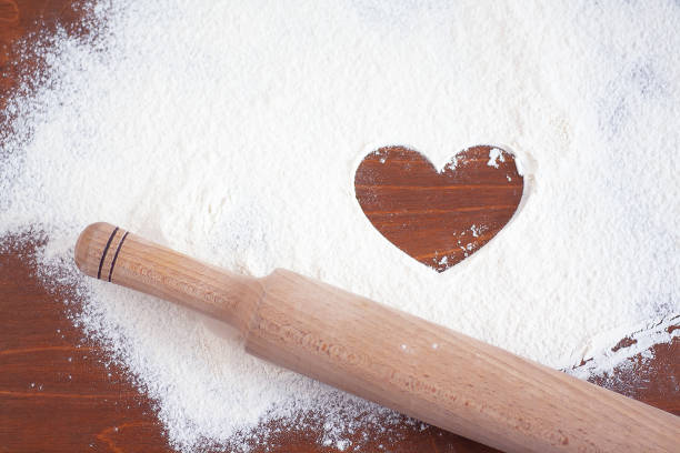 istock rolling pin and flour with heart symbol 1299473093