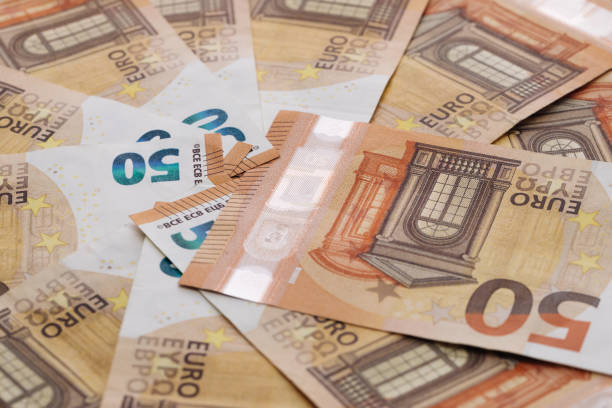 50 euro cash macro part. european union currency. stack of 50 euro banknotes - european union coin european union currency coin isolated objects imagens e fotografias de stock
