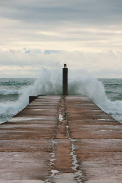 istock Big ocean wave hit in a jetty in a stormy day 1299474186