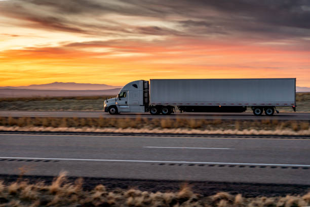 istock Long Haul Semi-Truck Rolling Down a Four-Lane Highway at Dusk 1299474819