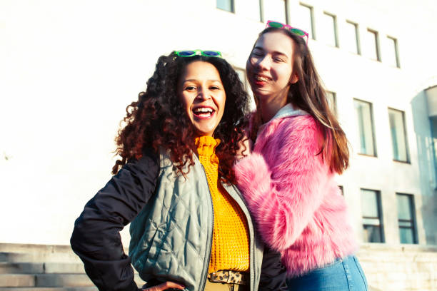 istock two pretty student girlfriends happy smiling outside at university building, caucasian and african woman, lifestyle people concept 1299476379