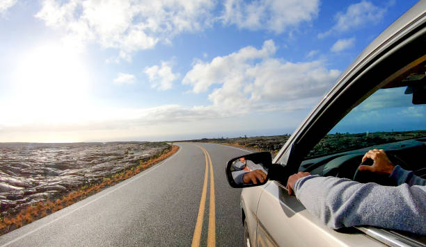 istock POV along car driving down open road at sunrise 1299476854