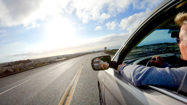 istock POV along car driving down open road at sunrise 1299476890