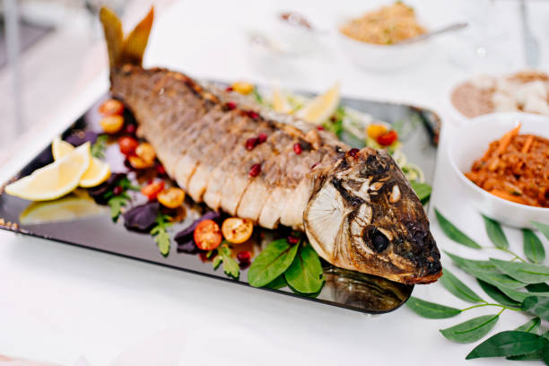 istock beautiful serve baked whole and sliced into pieces of fish. 1299478034