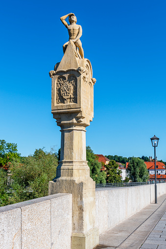 sculpture called Bruckmandl on old stone bridge in Regensburg was built in 1854 . The builders are\nAnton Blank (sculpture) and Michael Mauerer (pillar)