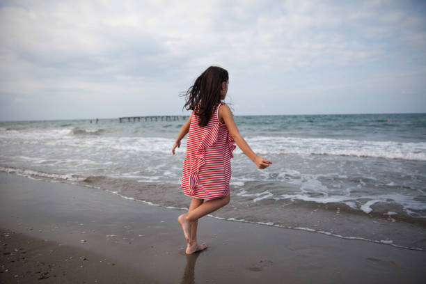 A girl having fun by the sea.