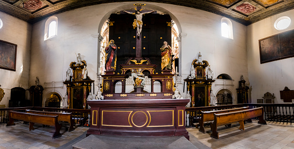 Background image of ethereal church interior in all white with stained glass window at altar