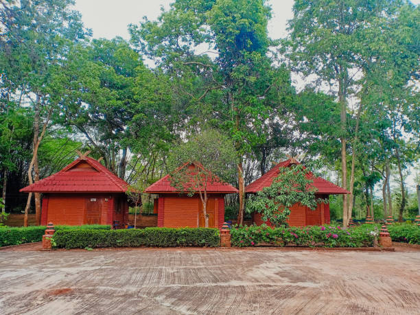 istock Three red brick earthen house or homestay among the trees. 1299480594