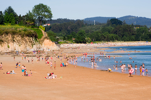 Ares, A Coruña, Spain- July 13, 2020: Many tourists and locals enjoying Ares beach in A Coruña province, Galicia, Spain, summertime.