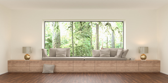A cozy bench at a large panoramic window with built-in storage space. On the outside a rainforest landscape. 3d render