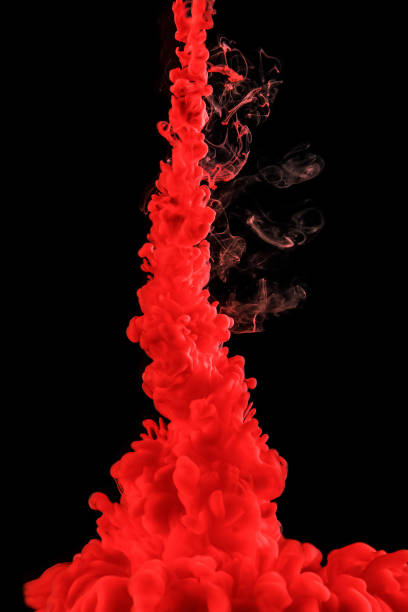 istock Red abstract background. Ink splashes in water on black. 1299483138