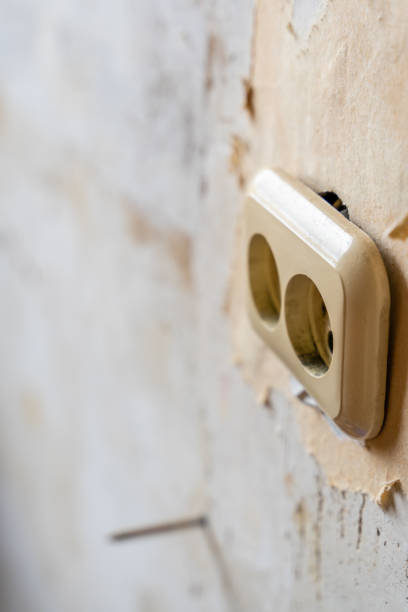 istock Electricity Outlet in Room remodeling Process with White Grunge Wall for Copy Space - Out of Focus, Abstract 1299486294