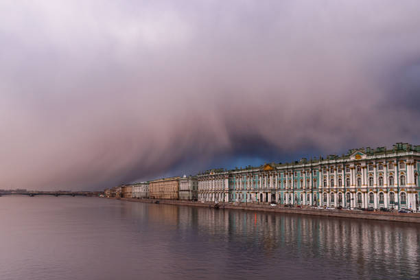 Dramatic sunset and weather front with snow storm risk in spring over the Hermitage in St. Petersburg. View on Neva river.