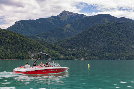 Sankt Gilgen, Austria - July 19, 2017: Family sailing in speedboat at Wolfgangsee near Sankt Gilgen, Austria