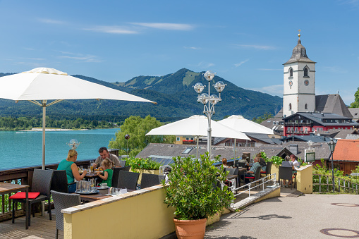 Sankt Wolfgang, Austria - July 19, 2017: Family eating at outside terrace in restaurant Sankt Wolfgang am Wolfgangsee