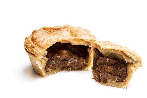 istock Puff pastry steak pie on baking paper isolated on white 1299489212