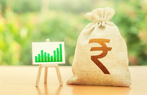 Indian rupee money bag and easel with green positive growth graph. Economic development. Business sentiment. High deposits profitability. Recovery and growth of economy, good investment attractiveness