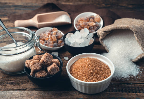 Many different types of sugar on a wooden background. Side view Many different types of sugar on a wooden background. Side view. Culinary background with vintage tinting. The concept of food products. carbohydrate food type stock pictures, royalty-free photos & images