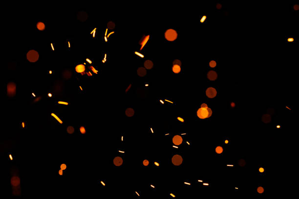 istock Bright yellow sparks on a black background, yellow bright round bokeh. 1299490287