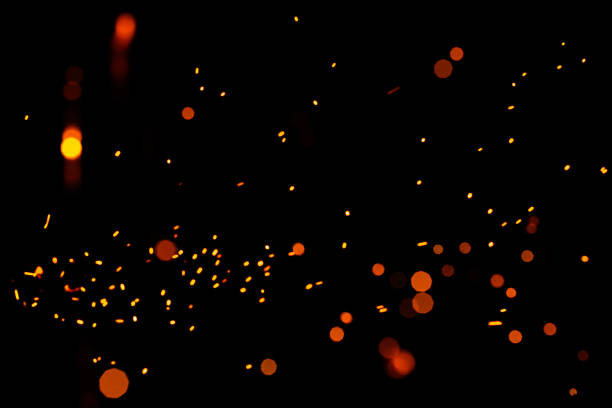 istock Bright yellow sparks on a black background, yellow bright round bokeh. 1299490455