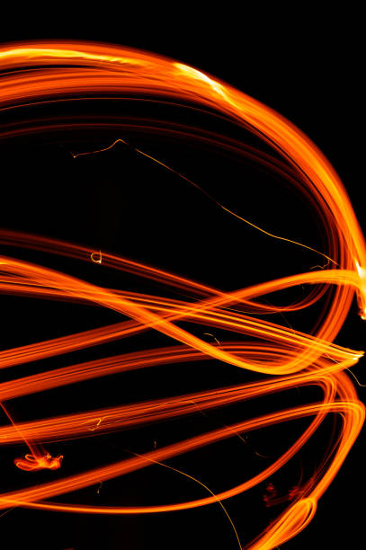 istock Drawing shapes with fire at night, infinity sign, bright colors on night background, fun with fire. 1299491354