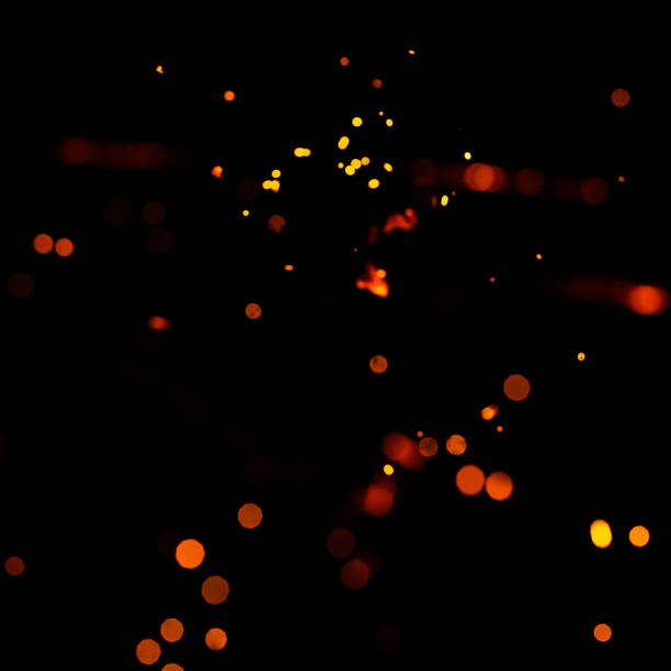 istock Bright yellow sparks on a black background, yellow bright round bokeh. 1299492285