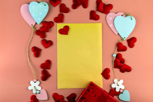istock Valentine's Day copy space. On a blue background, a gift box and a red bow, colored hearts tied together, candy. In the center there is a place for text. 1299492598