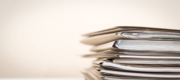 Extremely Close up Stack of Documents Folders on Office Desk Waiting to be Completed. stock photo