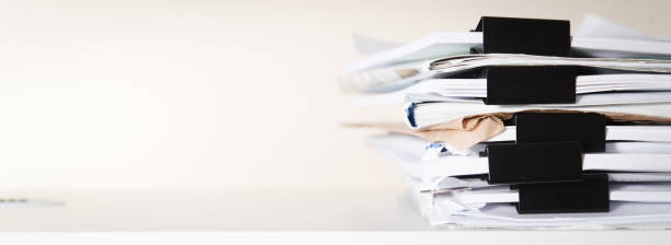 Extremely Close up Stack of Documents Folders on Office Desk Waiting to be Completed. stock photo