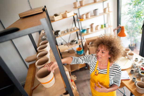 istock High angle view of a craftswoman arranging concrete pots on a shelf 1299496130