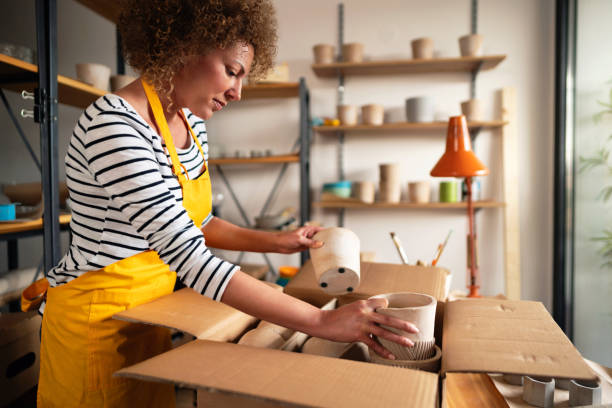 istock Craftswoman packing her concrete products for sale 1299496139