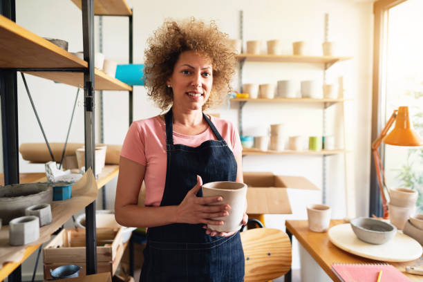 istock Portrait of a woman artisan in a small creative pottery studio 1299496155