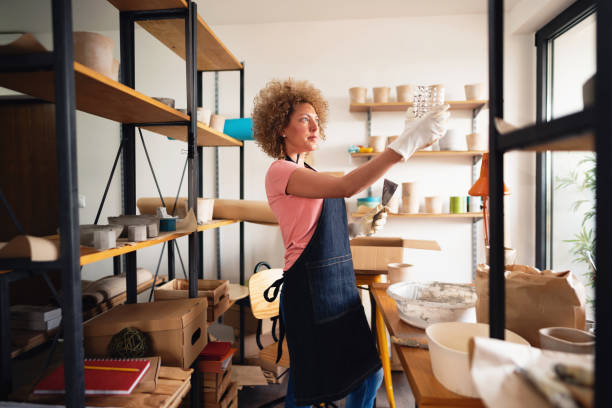 istock Woman potter working on a new flowerpot in her studio 1299496159
