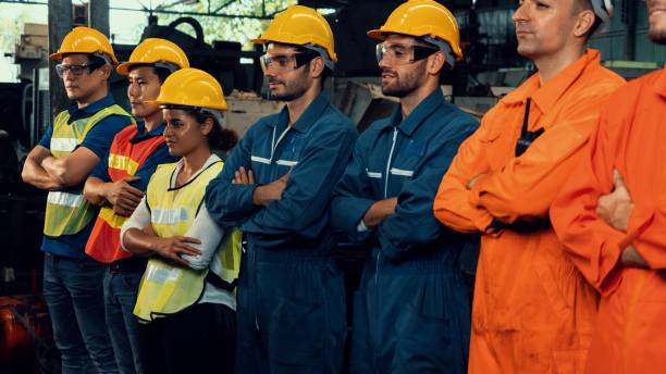 istock Skillful worker stand together showing teamwork in the factory . 1299497197