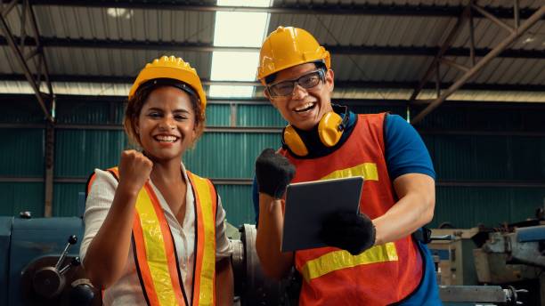 istock Two skillful factory engineer or worker happy portrait looking at camera 1299497221