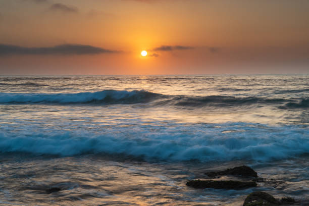 istock Suns up - a soft and hazy sunrise seascape 1299498741