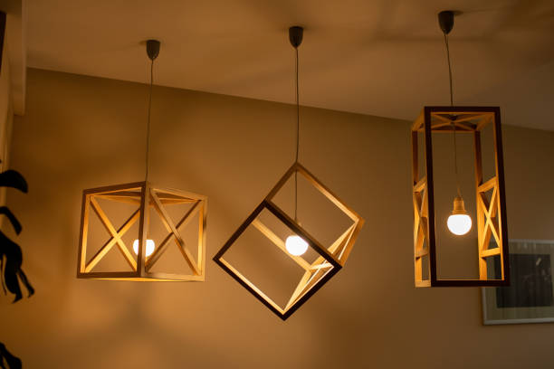 Modern ceiling lights bulbs lamp made of wooden frame geometric shape interior and loft style decorating with white wooden wall Modern ceiling lights bulbs lamp made of wooden frame geometric shape interior and loft style decorating with white wooden wall. pendant stock pictures, royalty-free photos & images