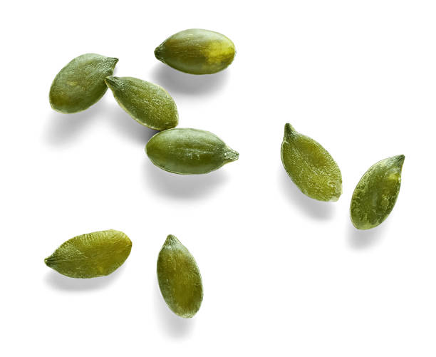 istock peeled pumpkin seeds close-up on white background 1299506503