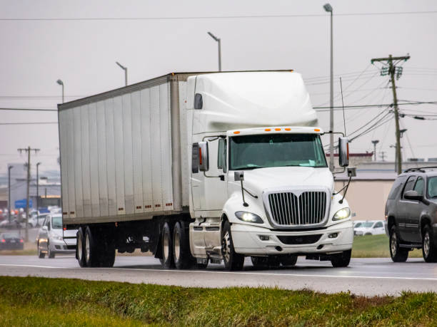 istock Generic White 18 Wheeler In Wet Traffic During Winter 1299510751
